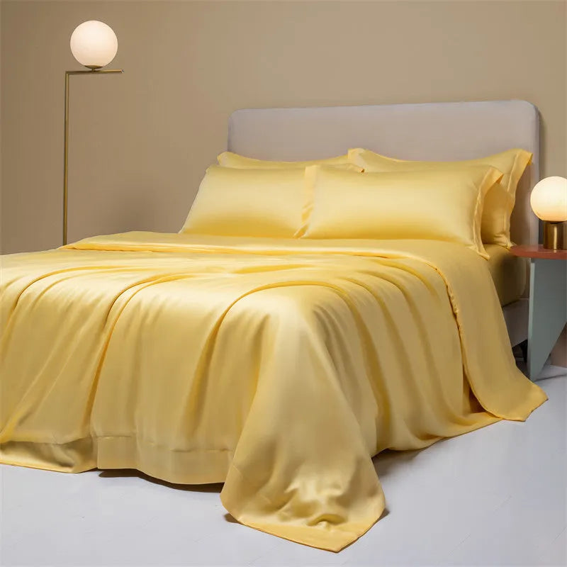 A modern, neatly made bed with a Lenzing Tencel duvet cover and pillowcases in a choice of nine colours like Sea Salt Blue.