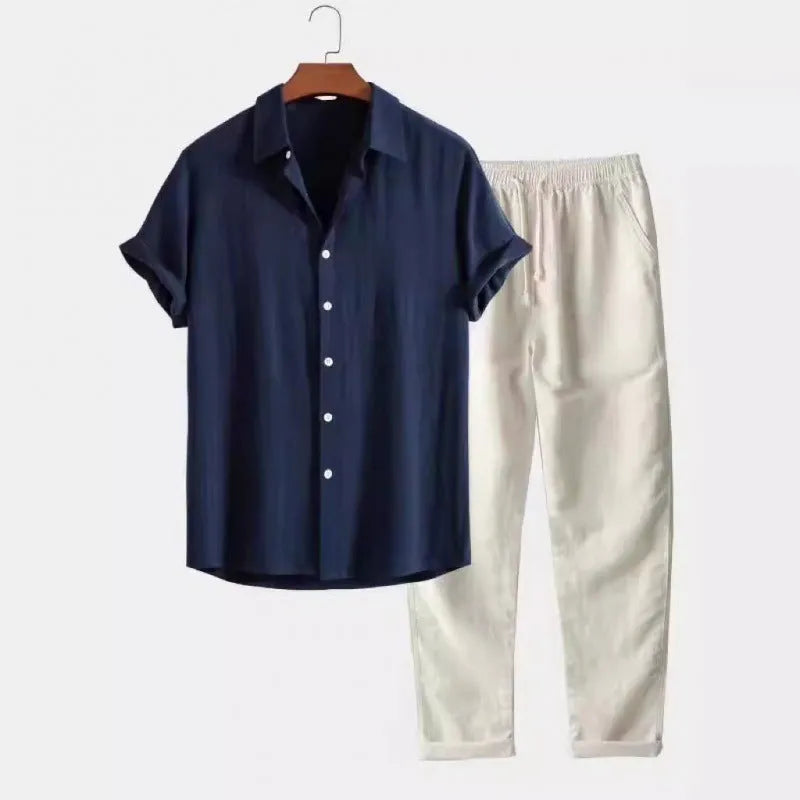 Man wearing a loose-fit short sleeve shirt and matching trousers from a casual linen-look polyester suit.