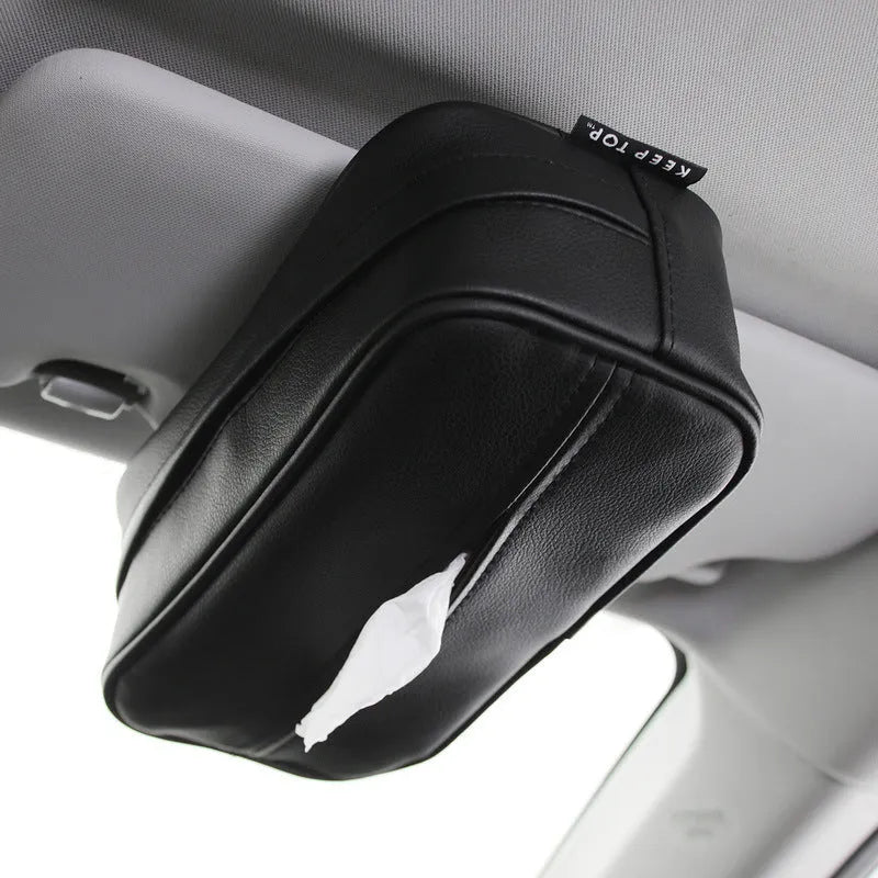 Black PU leather box with hanging loop on a car seat.