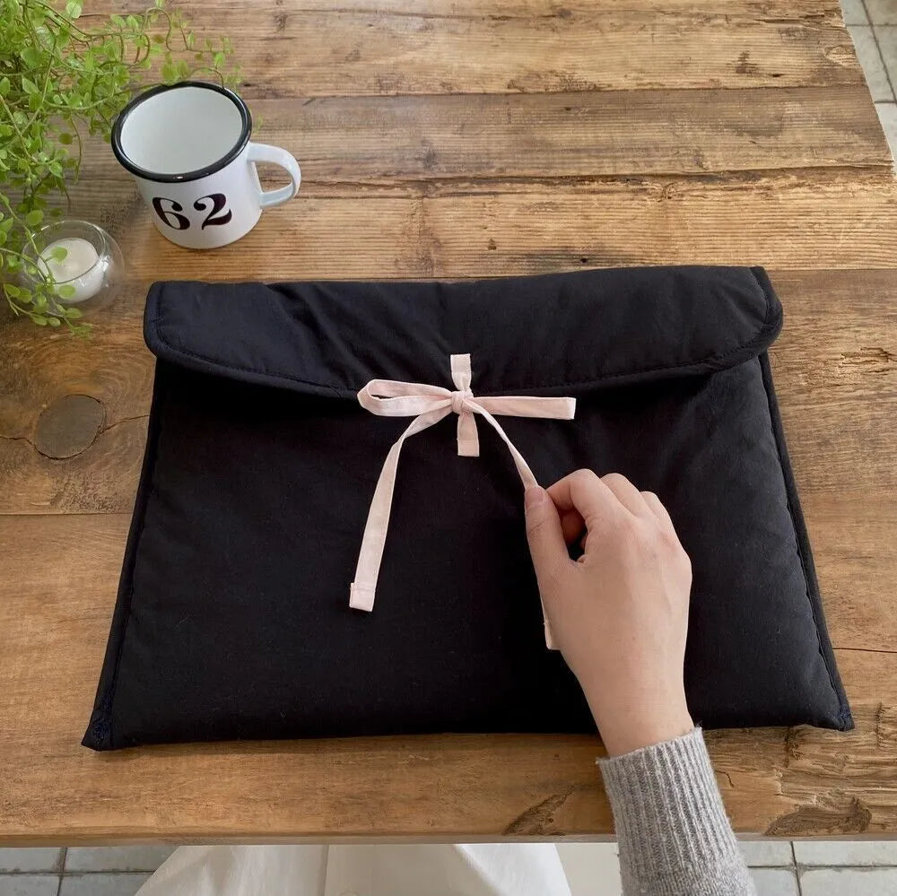 Black and white women's quilted nylon laptop bag with ballet bow in two size options.