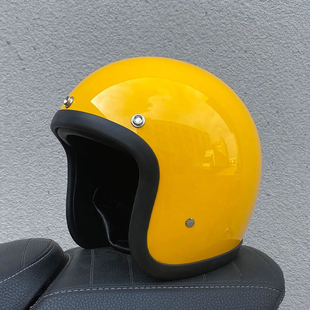 Retro-style motorcycle half helmet in cement grey with a glossy fibreglass shell on a plain background.