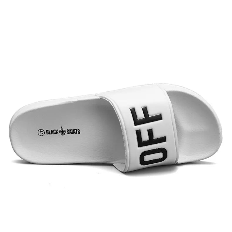 A pair of open-toe men's slippers with a rubber sole, shown in black and white colour options.
