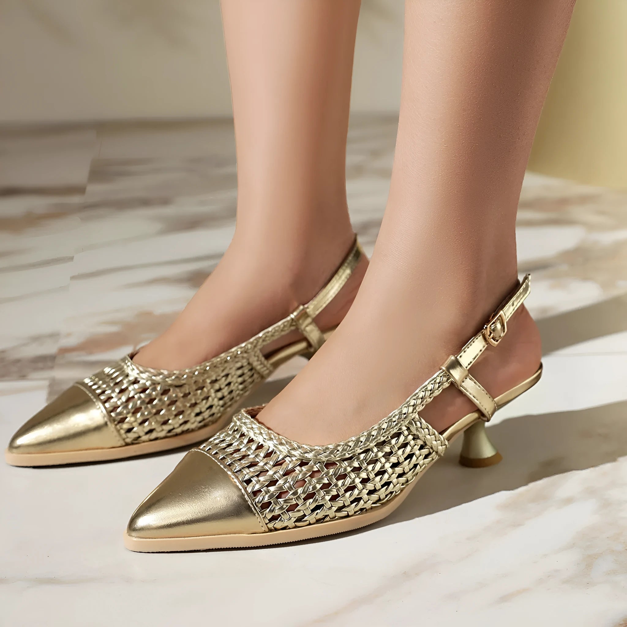 Women's cat heel hollow sandals in black, gold, and silver with buckle fastening and pointed toe.