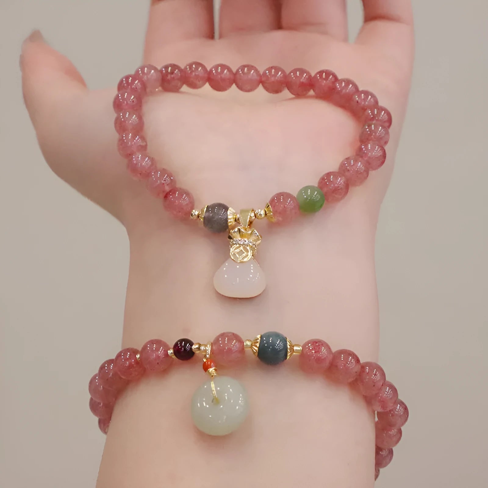 Strawberry quartz bracelet with geometric shapes, purse charm, and safety buckle closure