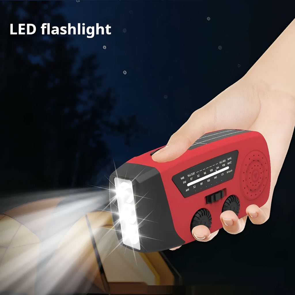 Red rechargeable emergency hand radio with built-in torch and wrist strap for disaster preparedness kits