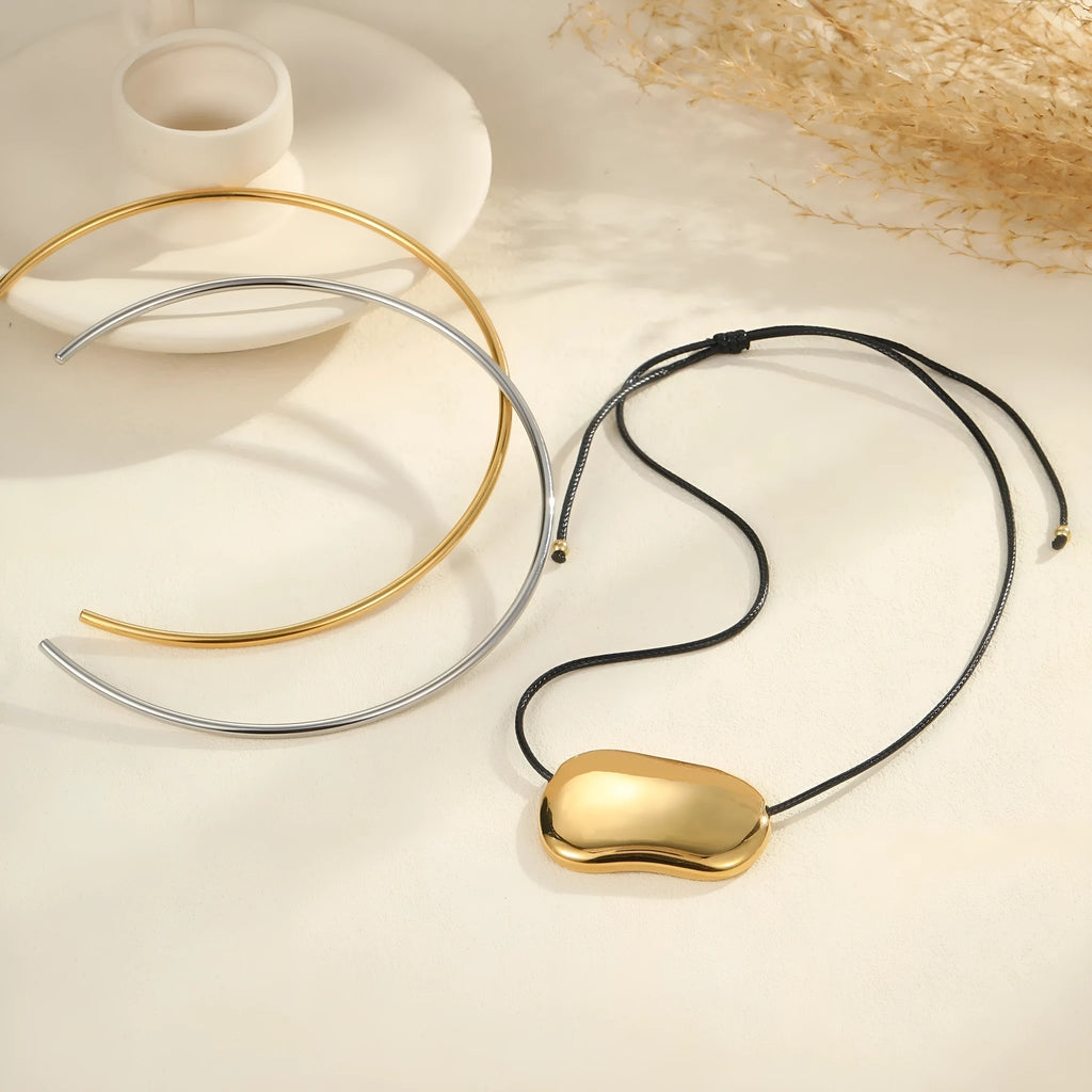 Black rope titanium steel necklace with geometric pendants on a chain, available in gold or silver as a collar or full necklace.