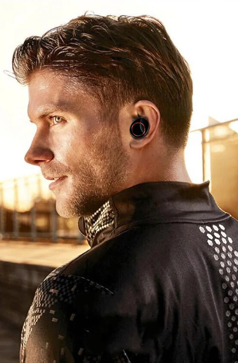 Black X11 wireless Bluetooth earbuds inside their white charging case, with silicone ear sleeves.