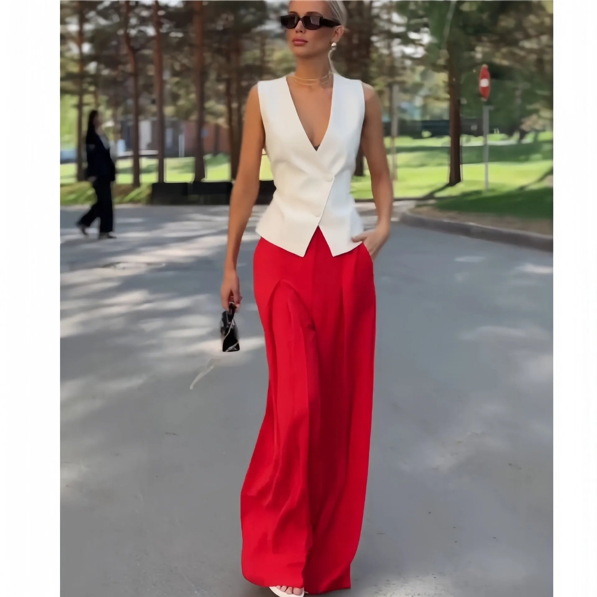 Women's beige polyester two-piece set with sleeveless deep V-neck top and high-waist wide-leg trousers.