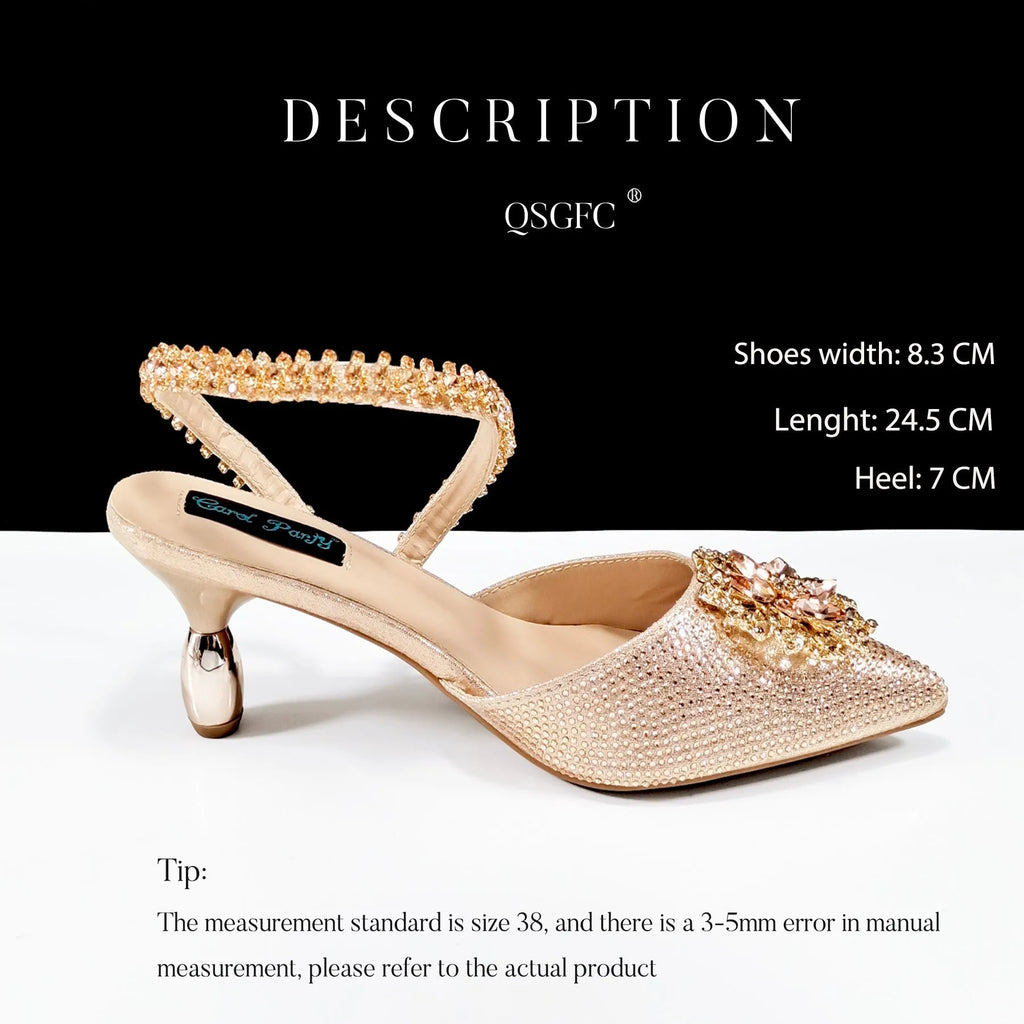 Women's black high heel shoe with floral rhinestone detail and matching hard clutch bag.
