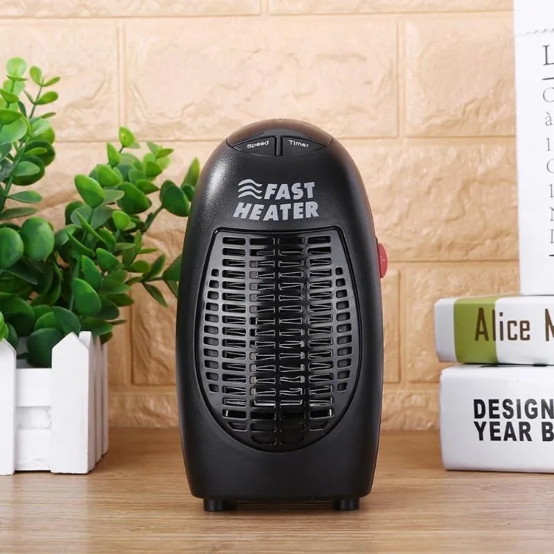 Small black ceramic electric heater with digital display and a rotating plug on a desk.