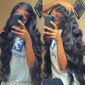 Black synthetic front lace long curly wig with side bangs, density 180, length 22 inch, on display
