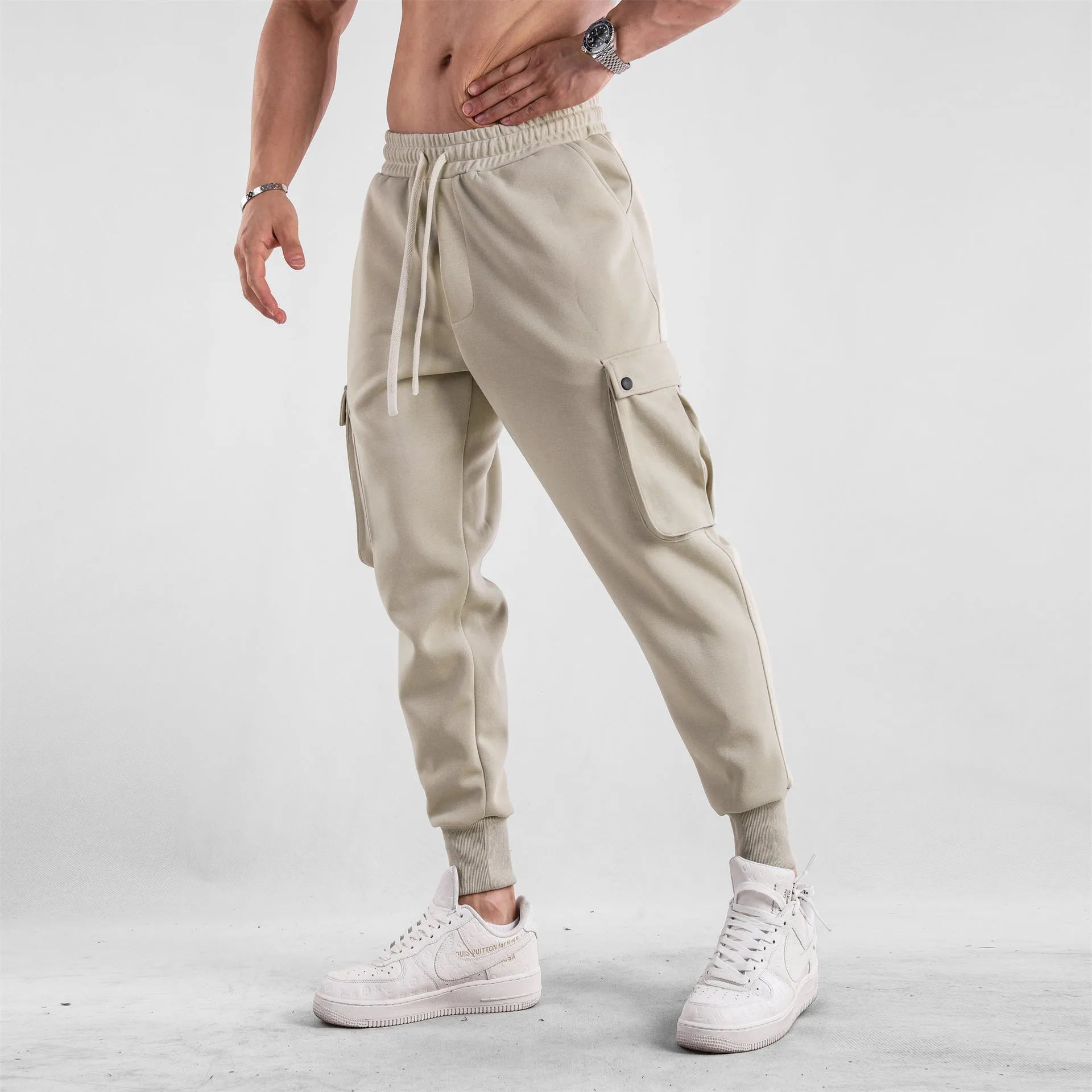 Men's loose-fit cotton sports trousers with ankle ties and multiple pockets in solid colour