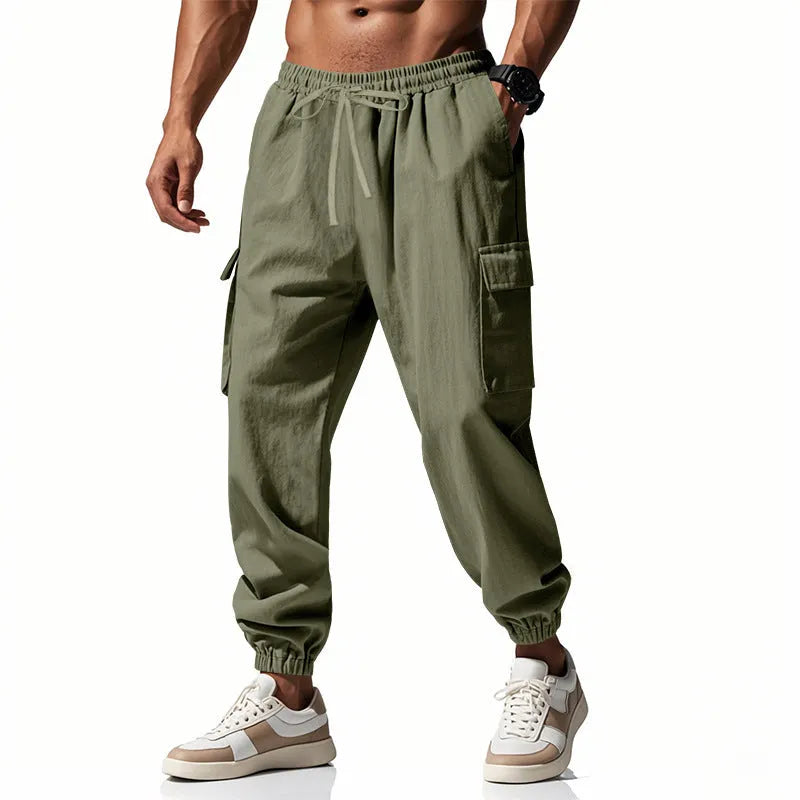 Men's solid colour linen trousers with ankle-tied cuffs, drawstring waist, and multiple pockets.