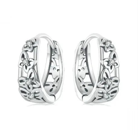 Close-up of retro hollow butterfly shaped stud earrings in sterling silver with zircon stones.
