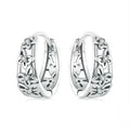 Close-up of retro hollow butterfly shaped stud earrings in sterling silver with zircon stones.