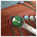 Handmade dried gypsophila and clover flower bookmark ruler on a book, showing 12cm length.