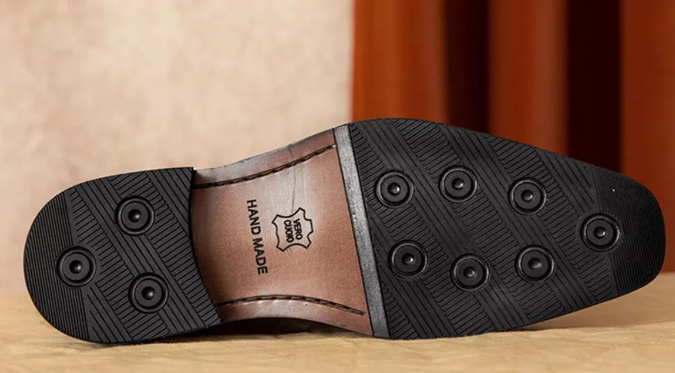Men's black and brown genuine leather slip-on loafers with a fringed detail and rubber sole.