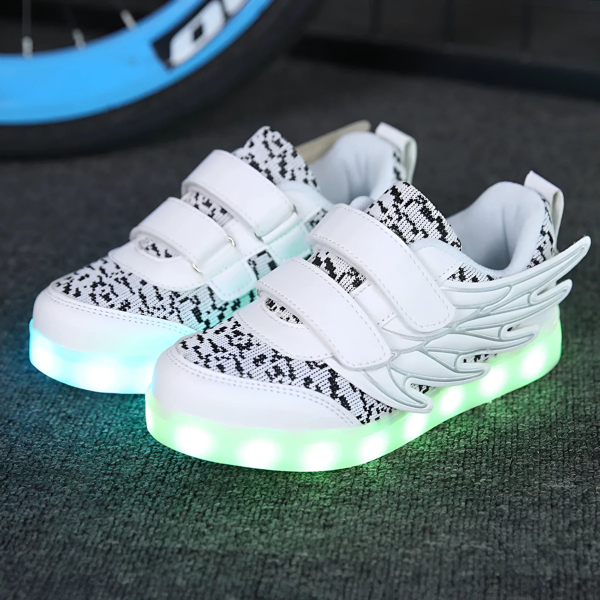 Children's plum red and white LED light-up sneakers with USB charging port on the side.