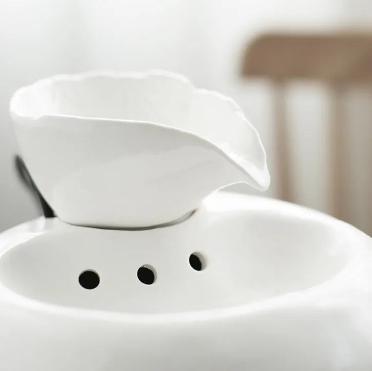 White porcelain leaf-shaped automatic cat water dispenser on floor