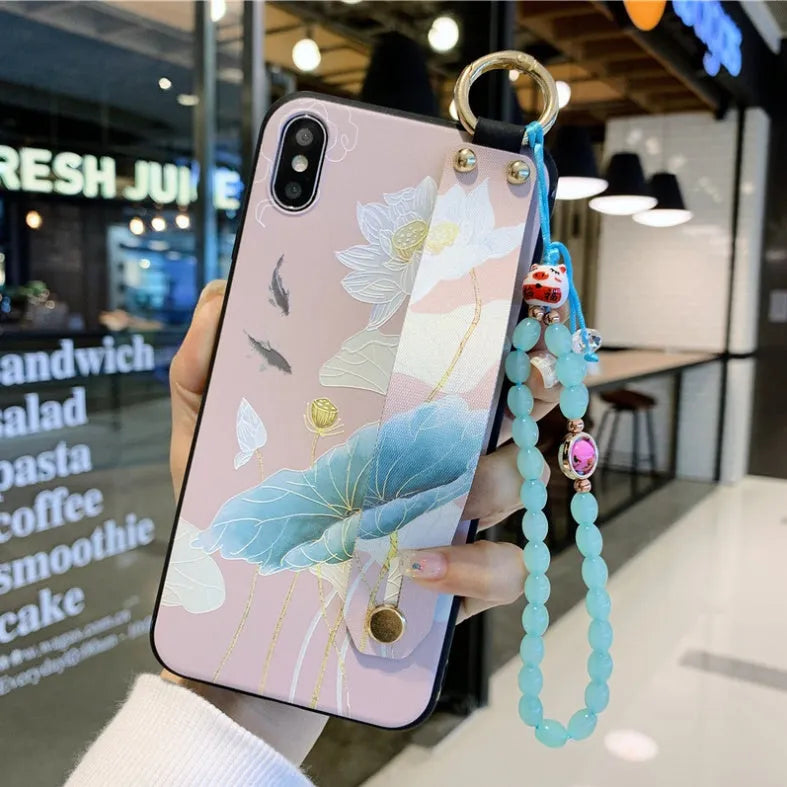 Rose flower design wrist strap case for iPhone on a table
