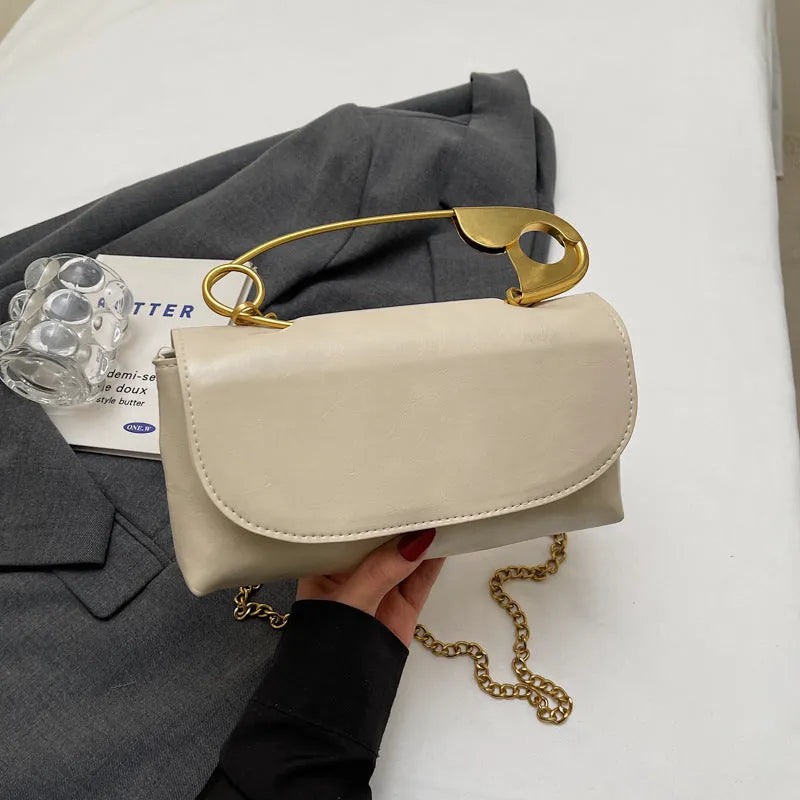 Creative personality paper clip shoulder handbag in PU leather with sandwich pocket and file bag interior.