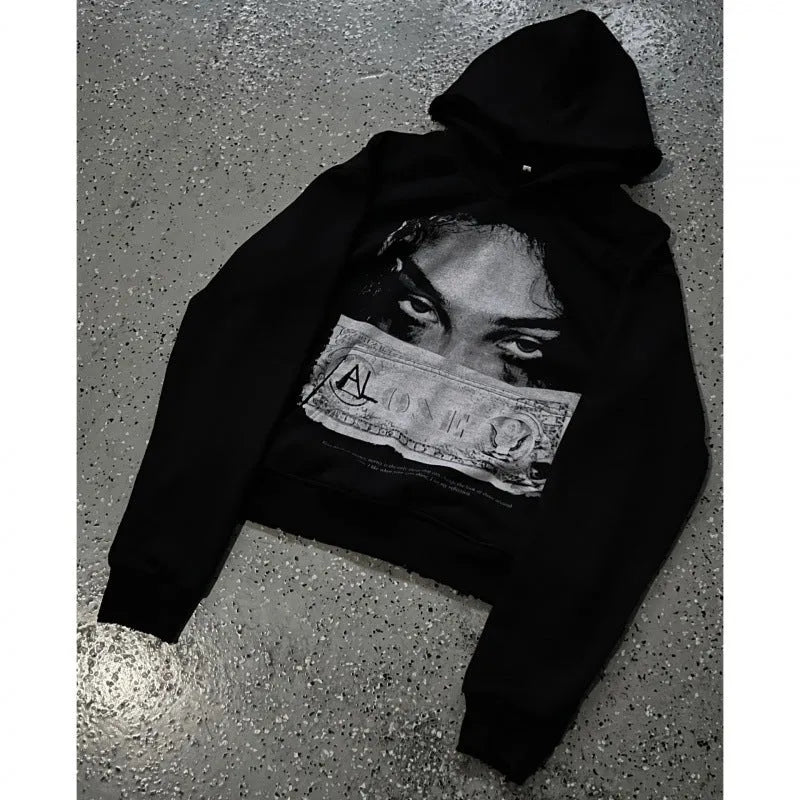 Black women's loose-fit hoodie with a cartoon print, shown in a casual setting.