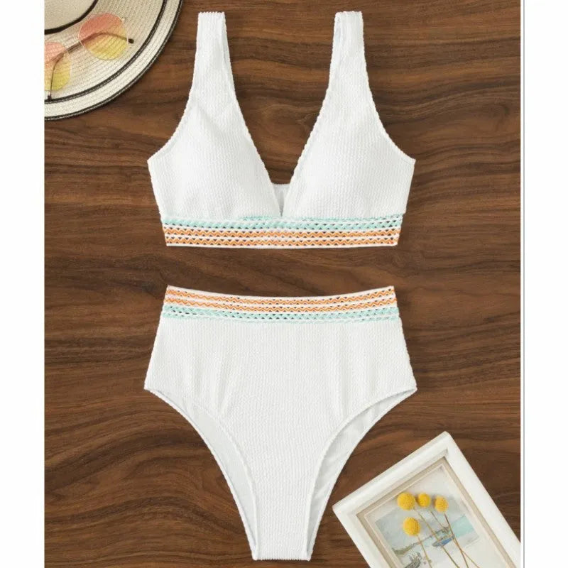 A pink high waist women's bikini brief with a split leg design, laid flat.