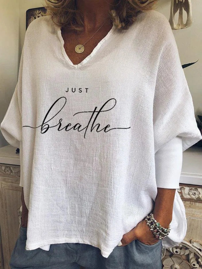 Woman wearing a loose V-neck long sleeve top in a digitally printed brushed silk fabric