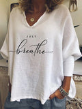 Woman wearing a loose V-neck long sleeve top in a digitally printed brushed silk fabric
