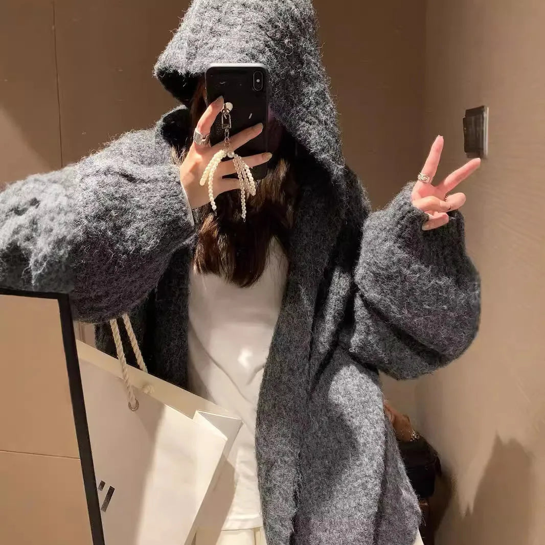 Women's brown retro-style hooded cardigan with a thick knit texture on a hanger.