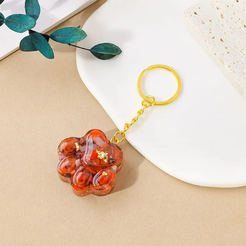 Small natural crystal cat's paw pendant on a metal keyring, available in various stone colours.