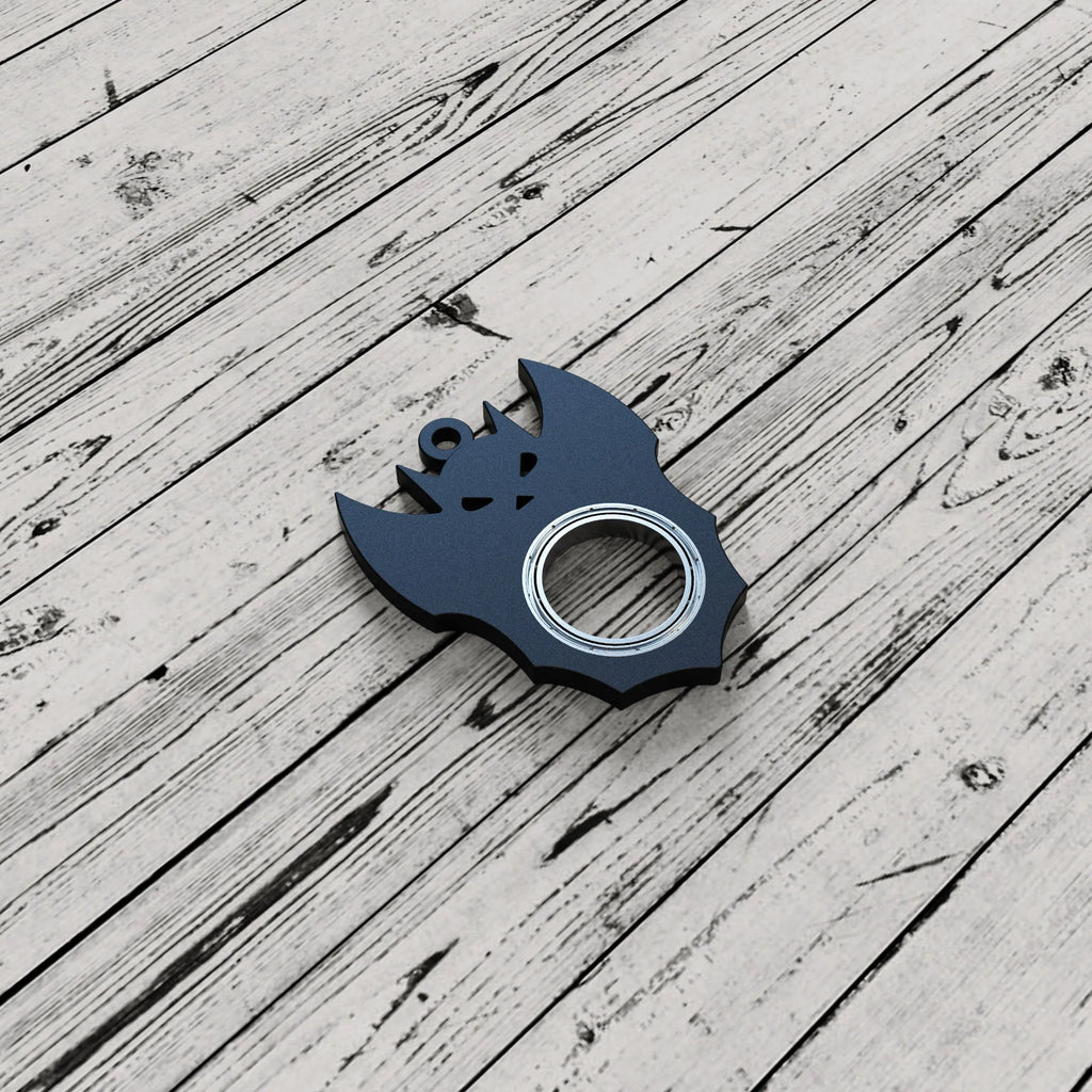 Black plastic Halloween bat demon ghost fidget spinner keychain with bottle opener on a dark background