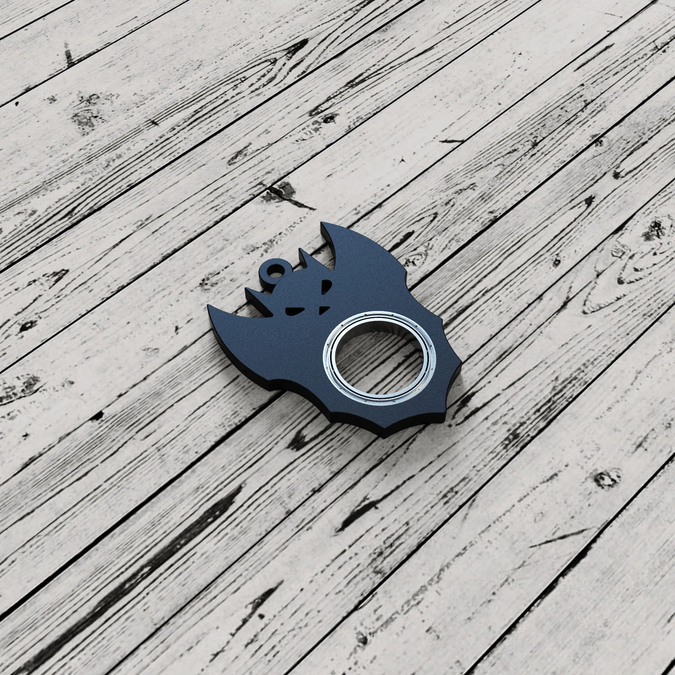 Black plastic Halloween bat demon ghost fidget spinner keychain with bottle opener on a dark background