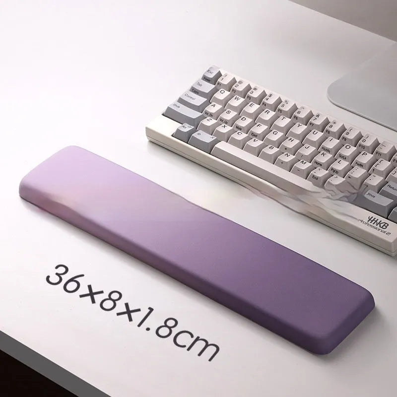Square black silica gel mouse pad with raised keyboard support area and integrated wrist rest on a wooden desk.