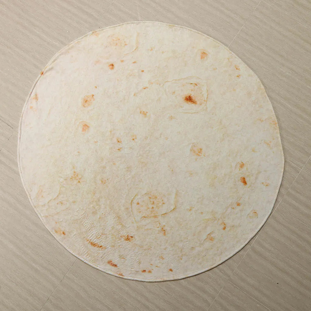 Coral coloured round flannel burrito blanket on a grey background