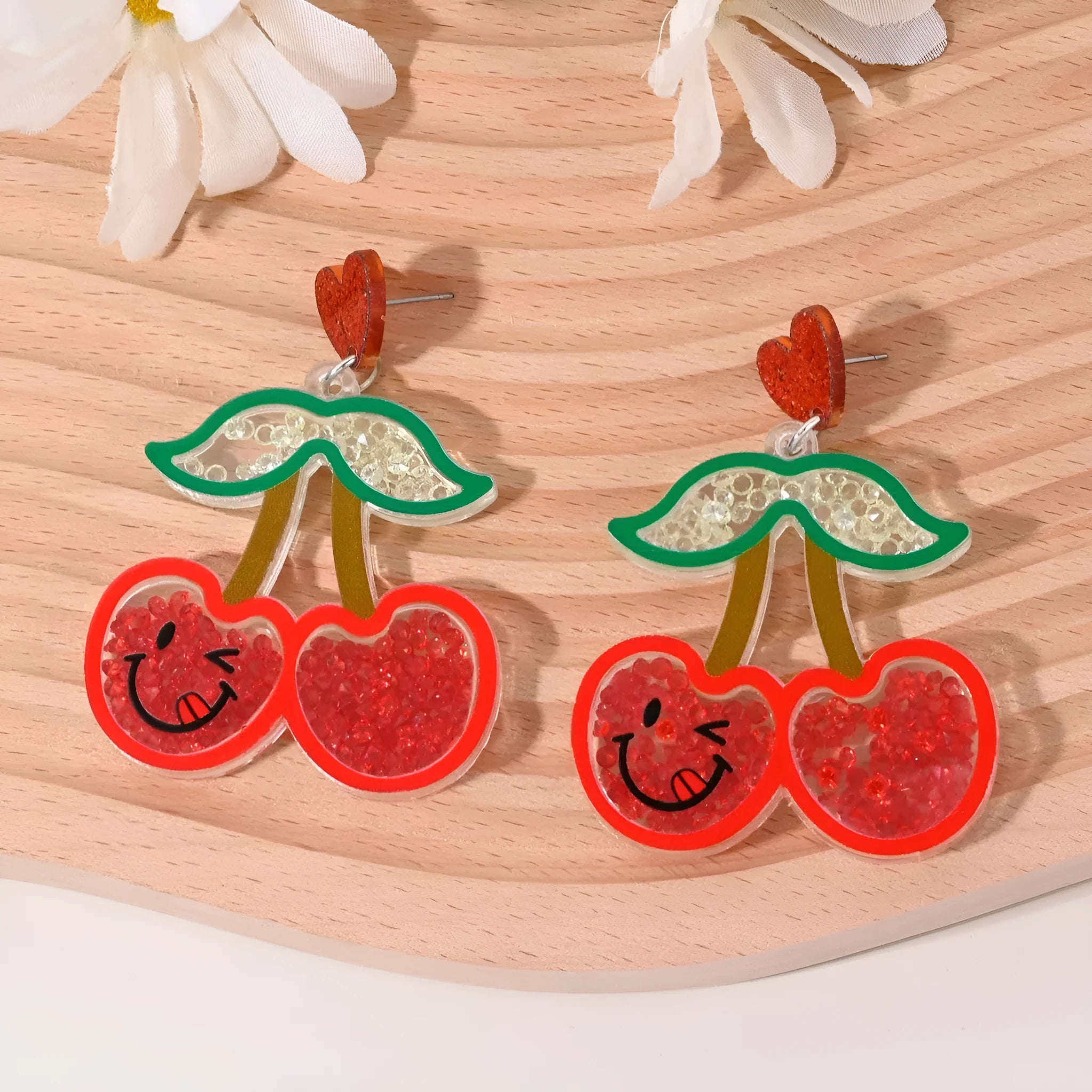 Colourful acrylic drop earrings with fruit and dessert charms including strawberry, cherry, pineapple, and watermelon.