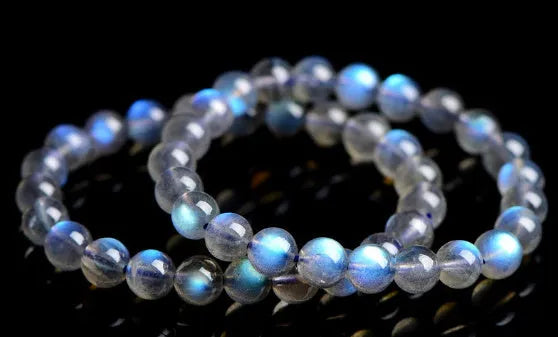 Natural cream coloured Blue Moonlight crystal bracelet on a wrist, showing minimalist unisex design.