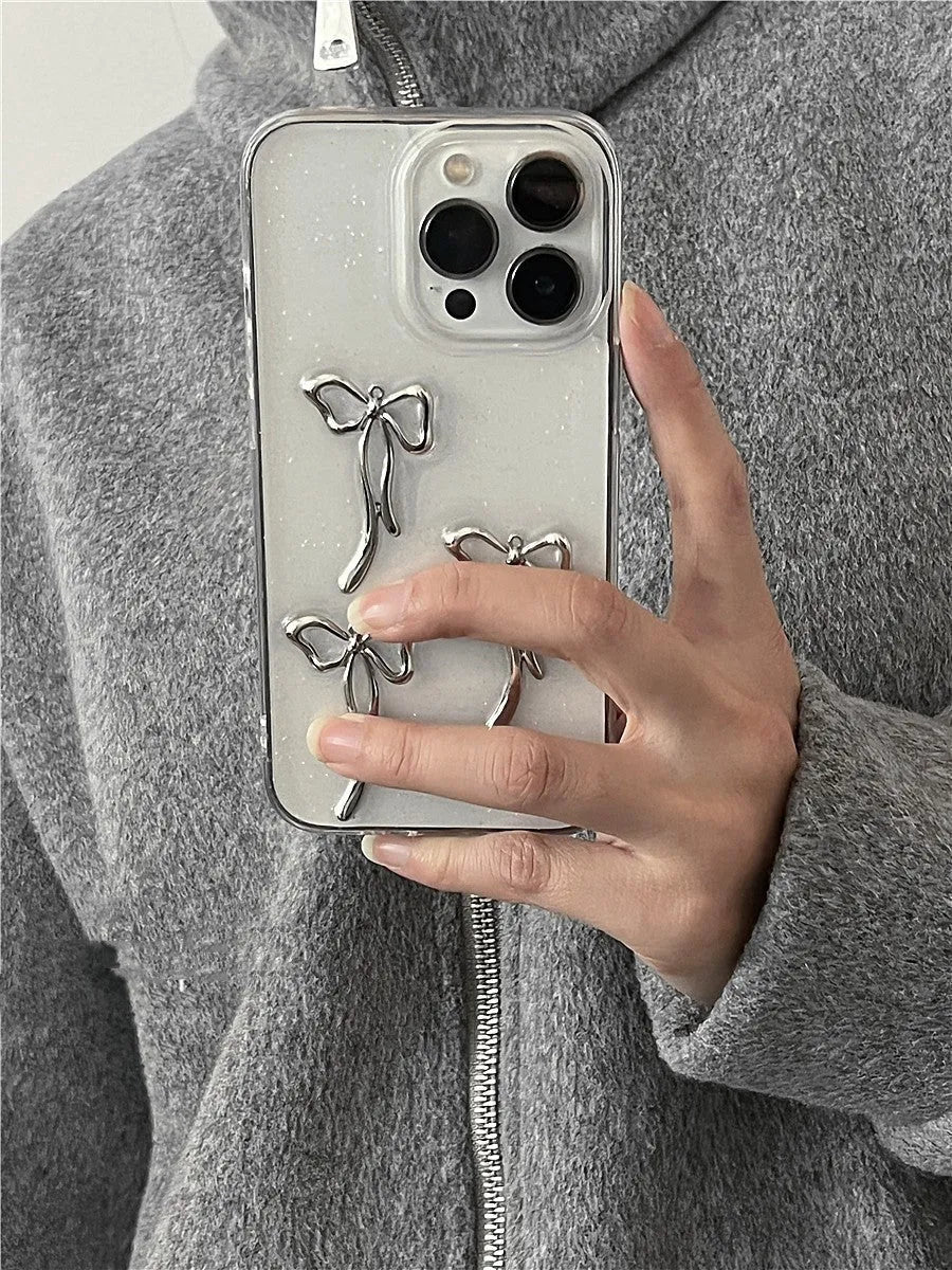 Metal bow iPhone case with anti-drop function and 3D epoxy drip glue detail, available for iPhone 15, 14, 13, 12, and 11 models.