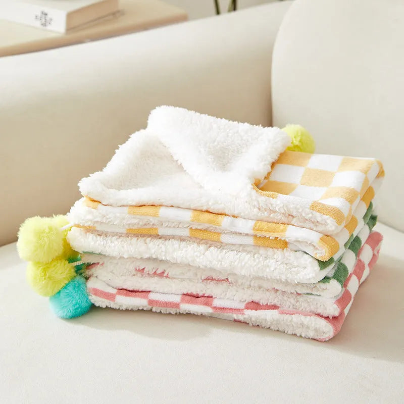 Soft plush pet blanket with plaid pattern and fur ball decoration for cats and dogs