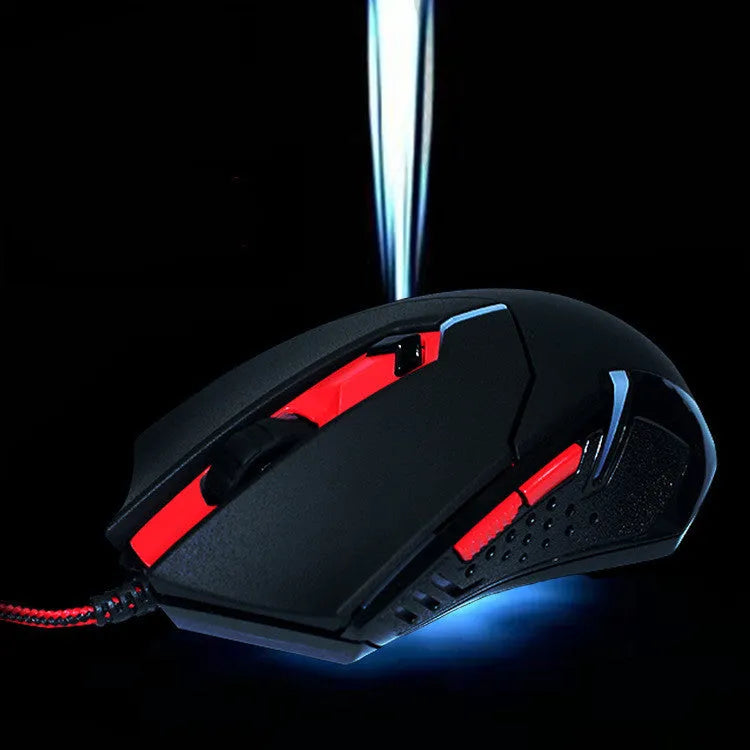 Black and red wired USB gaming mouse with six buttons and ergonomic shape on a desktop.