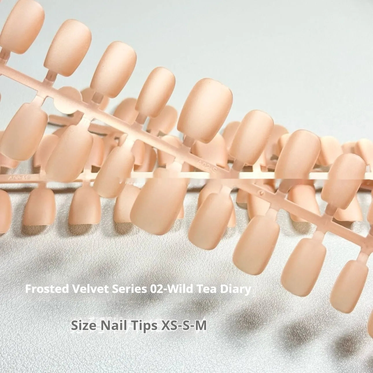 Frosted velvet Cat's Eye effect artificial nails in short ladder sizes on a display card.