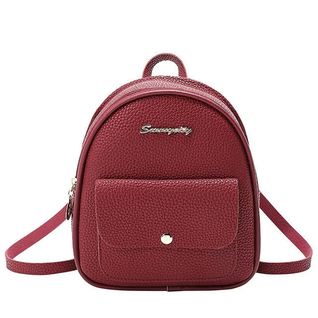 Compact black PU women's backpack shown as a shoulder bag, with zipper closure and dimensions provided.