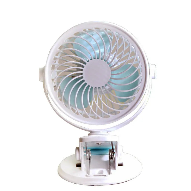 Small white USB desk fan with clip base and three blades on a wooden desk.