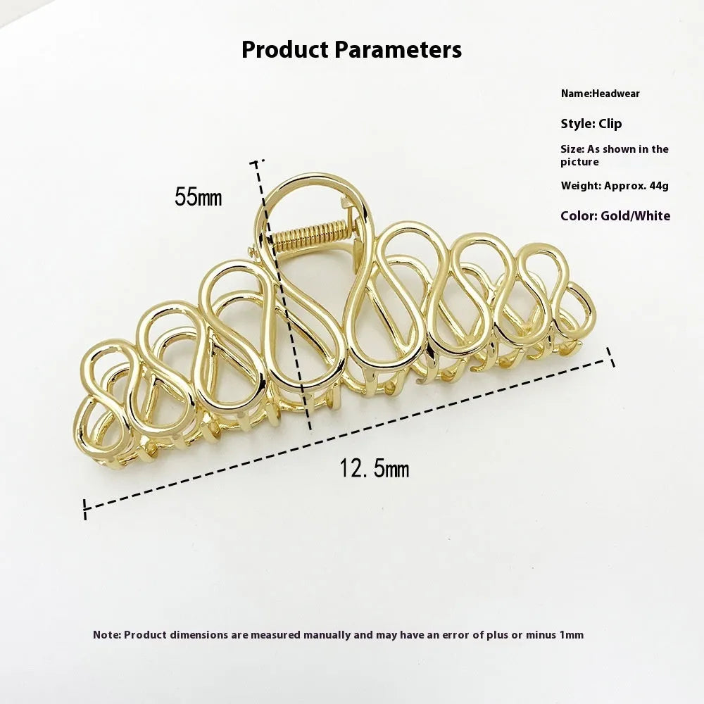 Minimalist large hair clip with gold electroplated finish and tassel detail on irregular geometric alloy design