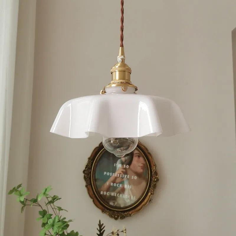 Medieval brass French chandelier light with glass shade, shown with adjustable cable.