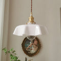 Medieval brass French chandelier light with glass shade, shown with adjustable cable.