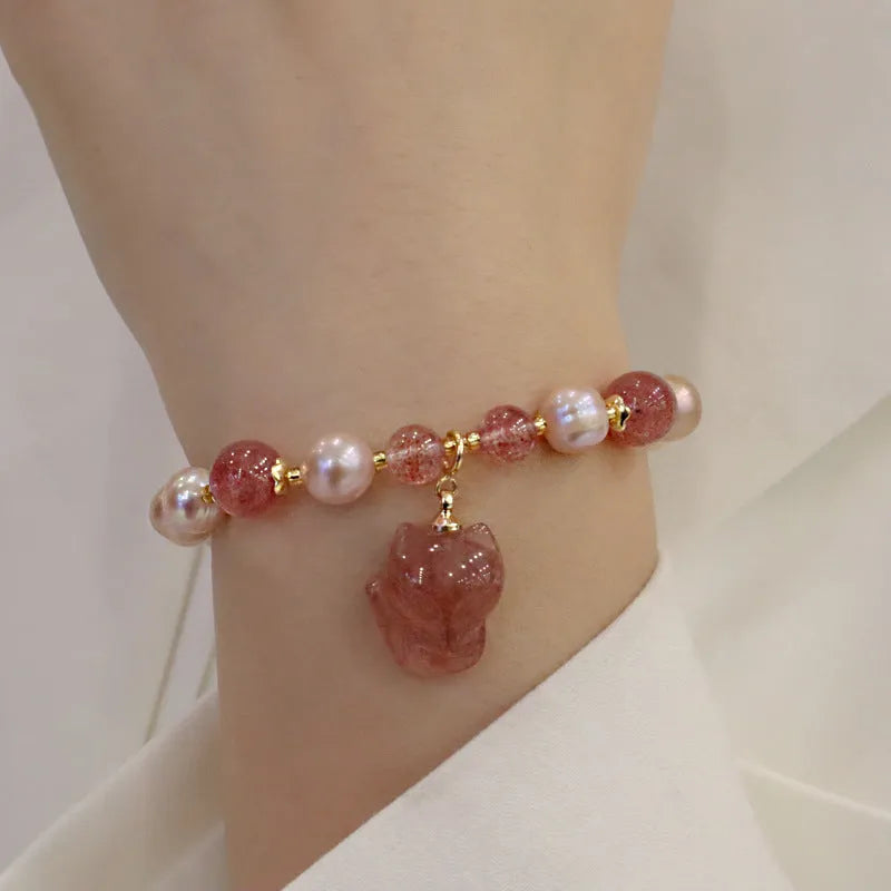 Women's light pink freshwater pearl bracelet with strawberry quartz beads and fox charm