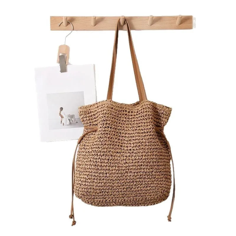 Large straw drawstring shoulder bag with polyester lining and mobile phone pocket in beige or coffee