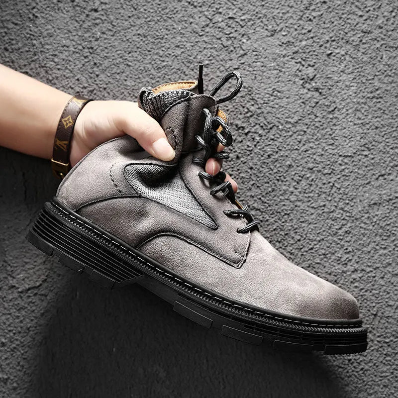 Men's brown frosted leather Martin boots with thick rubber sole on a wooden floor.