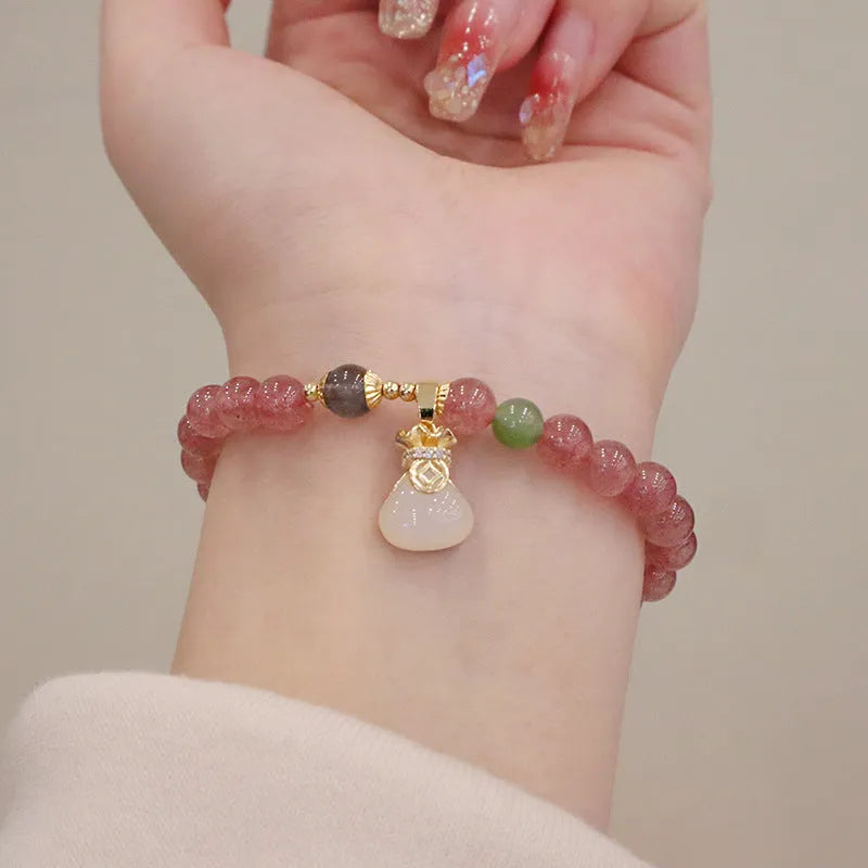 Strawberry quartz bracelet with geometric shapes, purse charm, and safety buckle closure